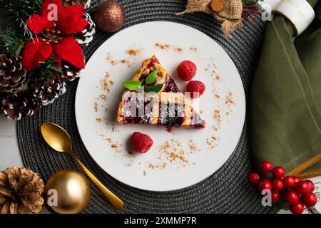 Delicious Italian crostata filled with red fruit jam on a christmas table for holidays. Stock Photo