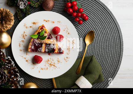 Delicious Italian crostata filled with red fruit jam on a christmas table for holidays. Stock Photo