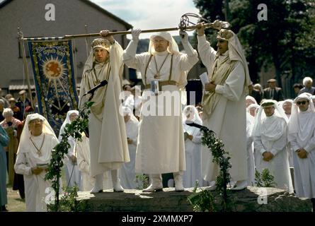 Gorsedd of Bards, the National Eisteddfod. The annual ceremony is a celebration and festival of the Welsh language and cultural heritage. Archdruids on the stage making announcements regarding the prize giving. The Archdruid partially withdraws a sword from its sheath three times, and cries 'A oes heddwch?' ('Is there peace?'), to which the assembly reply 'Heddwch' ('Peace'). The sword is then placed fully back into its sheath, and hence is never drawn fully.  Bala, Wales 2011, 2010s UK HOMER SYKES Stock Photo