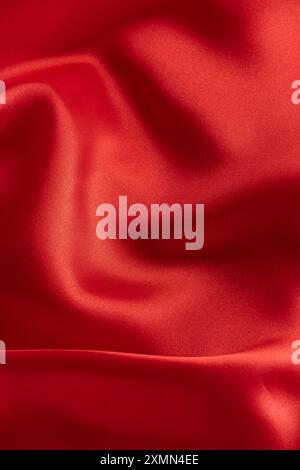 Closeup of rippled red satin fabric texture background Stock Photo