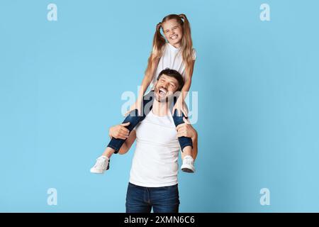 Happy Father And Daughter Having Fun Together On Blue Background Stock Photo