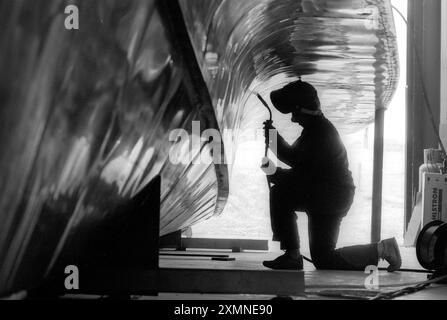 A welder working on the aluminium hull of a high speed launch, part of a fleet of 30 river taxis for the RIver Thames.   The launches were being built at Griffon Hovercraft in Netley Marsh, Hampshire and they began the water taxi service between Gravesend in Kent and the City of London.    20 May 1992    Picture by Roger Bamber Stock Photo