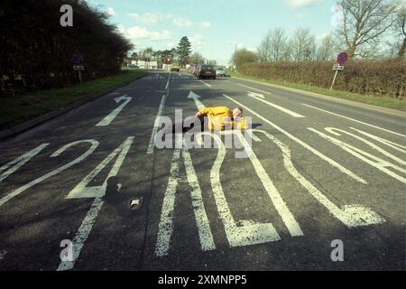 Dutch author Pieter Boogaart lies on the A272 at its junction with the A24 at Dragons Green near Billingshurst West Sussex . The road is the subject of 5 years work in writing a book A272 An Ode to a Road which has just been published7 March 2000 Picture by Roger Bamber Stock Photo