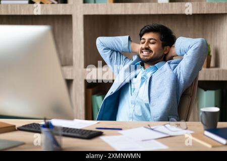 Relaxed Businessman Leaning Back In Office Chair Stock Photo