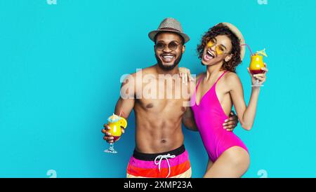 Happy Couple Enjoying Summer Cocktails on a Blue Background Stock Photo