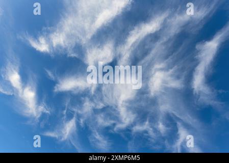 Abstract shapes formed by Cirrus clouds against a blue sky Stock Photo