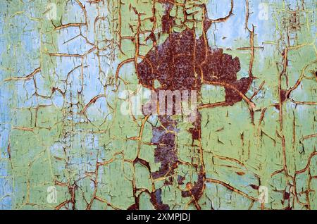 Cracked paint on the sheet metal with rust, texture. Damaged weathered coating. Abstract pattern, background. Trencin, Slovakia Stock Photo