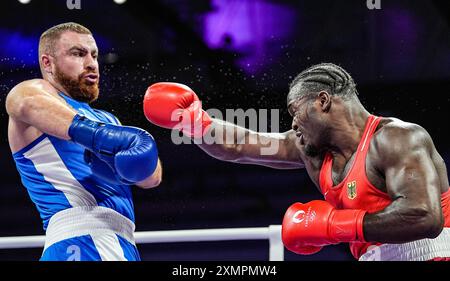 Paris, France. 29th July, 2024. Nelvie Raman Tiafack (R) of Germany competes with Mahammad Abdullayev of Azerbaijan during the men's 92kg preliminaries round of 16 of boxing at the Paris 2024 Olympic Games in the North Paris Arena in Paris, France, on July 29, 2024. Credit: Jiang Wenyao/Xinhua/Alamy Live News Stock Photo