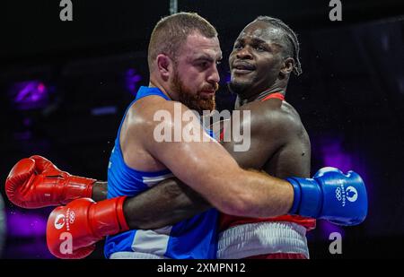 Paris, France. 29th July, 2024. Nelvie Raman Tiafack (R) of Germany competes with Mahammad Abdullayev of Azerbaijan during the men's 92kg preliminaries round of 16 of boxing at the Paris 2024 Olympic Games in the North Paris Arena in Paris, France, on July 29, 2024. Credit: Jiang Wenyao/Xinhua/Alamy Live News Stock Photo