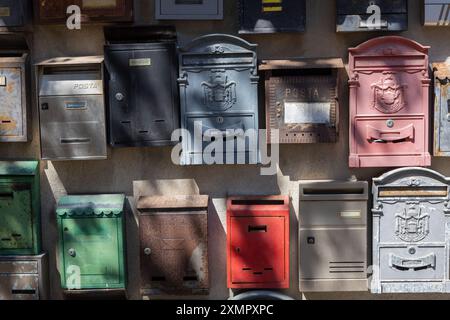 Variety of Vintage Mailboxes on Wall Stock Photo