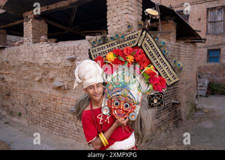 Traditional dancer Sroj Dilpakar, age 22, wears mask representing god Mhakali during Newari New Year festival  Bhaktapur, Kathmandu, Nepal Stock Photo