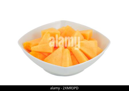 Slices of a melon in a white bowl isolated on white background. Stock Photo