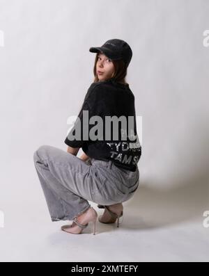 female grey style dark-haired cap streetstyle posing casual looking fitted cap scuffs tank top trucker hat Stock Photo