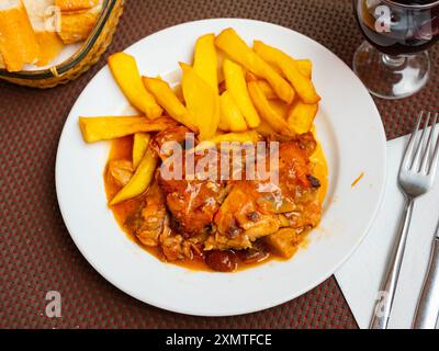 Braised rabbit served with potato garnish Stock Photo