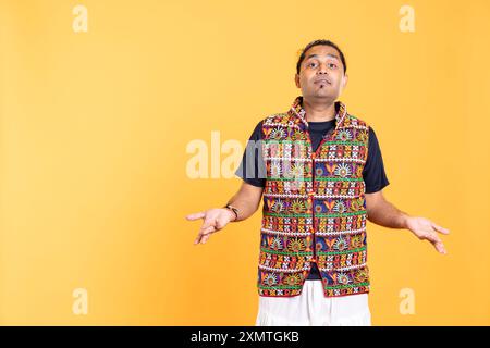 Portrait of perplexed man shrugging shoulders, hesitant to provide answer. Confused person doing questioning hand gesture, showing lack of knowledge, feeling indecisive, studio backdrop Stock Photo