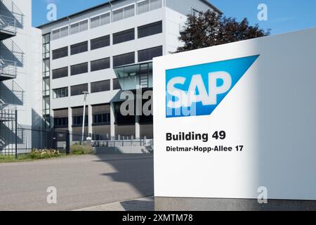 SAP SE logo prominently displayed on modern corporate headquarters facade, SAP corporate campus, symbolizing global software industry leadership, Wall Stock Photo