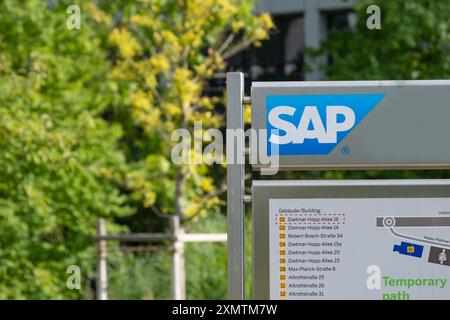 SAP SE logo prominently displayed on modern corporate headquarters facade, SAP corporate campus, symbolizing global software industry leadership, Wall Stock Photo