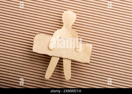 Paper man shape holding burnt note paper in hand Stock Photo