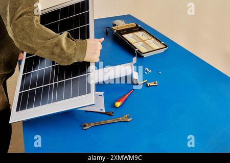 Use of solar energy in street lighting, installation of an autonomous, wireless LED lamp on mounting bracket with an LED panel. Stock Photo