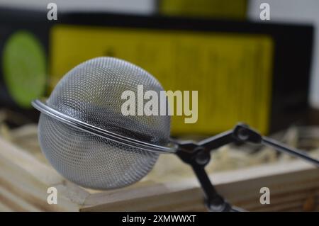 Stainless steel tea infuser for brewing loose leaf tea. Stock Photo