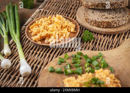 Egg spread with bread and chives on wooden boards, composing a tasty breakfast Stock Photo