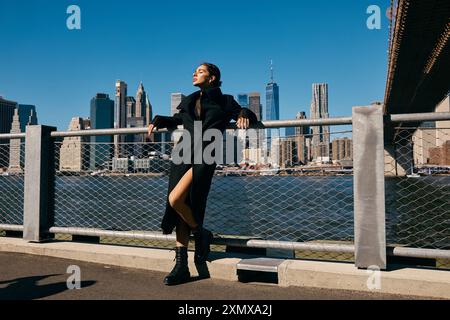 A young woman dances on a New York City street, her coat billowing in the wind. Stock Photo