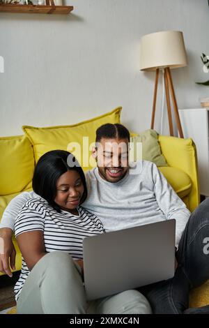 african american couple enjoys quality time together browsing online. Stock Photo