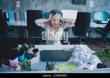 Photo of irritated annoyed mature lady accountant formalwear having no working ideas modern device indoors workplace workstation loft Stock Photo