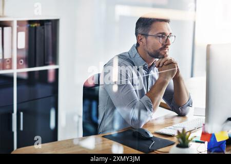 Business man, thinking and planning on computer for information technology or programming solution. Programmer or online developer reading on desktop Stock Photo