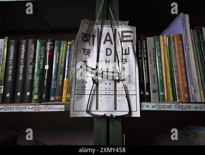 Reading glasses on display and eyesight test chart at a library, Rajshahi Division, Manda, Bangladesh Stock Photo
