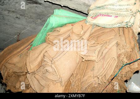 Uncover the natural charm of this textured burlap sack, showcasing frayed edges and a hint of vibrant fabric peeking through. Ideal for endeavors requ Stock Photo