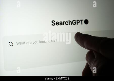 Search GPT search engine seen on the screen and finger pointing Stock Photo