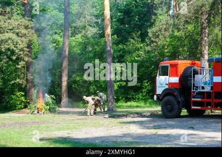 Foresters fighting fire in a forest. June 5, 2019. Forestry of Sviatoshyn district, Kievskaya oblast, Ukraine Stock Photo