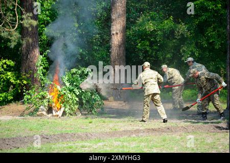 Foresters fighting fire in a forest. June 5, 2019. Forestry of Sviatoshyn district, Kievskaya oblast, Ukraine Stock Photo