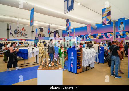 Paris 2024 official store located in a temporary structure on the Champs-Elysées, selling branded merchandise products Stock Photo