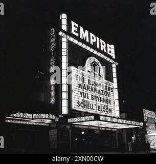 1958, historical, exterior of the Empire Cinema, Leicester Square, London, England, UK, where the film, The Brothers Karamazov starring Yul Brynner, Maria Schelll & Claire Bloom, presented by MGM in Metrocolor, is being screened. Orginally built in 1884 as a variety theatre, the Empire was acquired in 1925 by Metro-Goldwyn-Mayer and rebuilt as a movie theatre to show films. Stock Photo