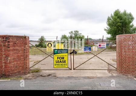 Development land for lease behind locked gates Stock Photo