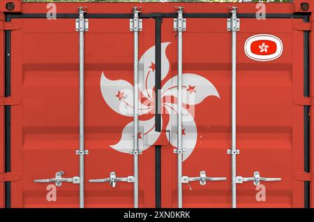 Hong kong flag depicted on metal doors of shipping cargo container outdoors in docks area close up Stock Photo