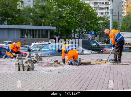 Moscow, Russia - May 12, 2023: Workers are replacing destroyed parts of the sidewalk Stock Photo
