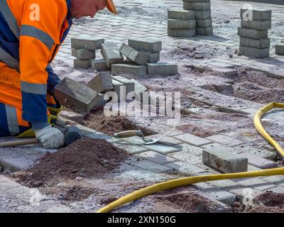 Restoring paving by partially replacing tiles Stock Photo