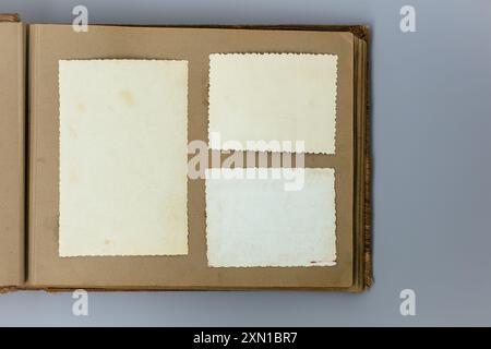 Clear blank photo frames to placed your pictures or text on old family album on grey background in retro style. Family traditions, memories and Stock Photo