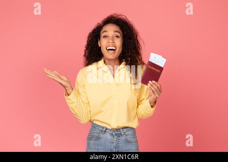 Excited Woman Holding Passport and Tickets Against Pink Background Stock Photo