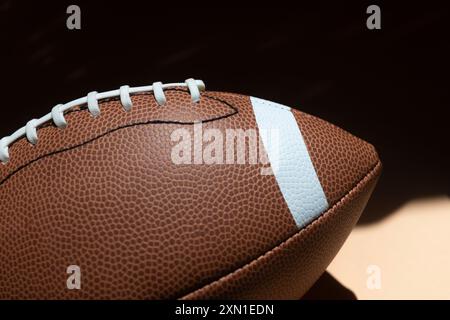 American football leather ball on yellow background. Game equipment horizontal sport theme poster, greeting cards, headers, website and app Stock Photo