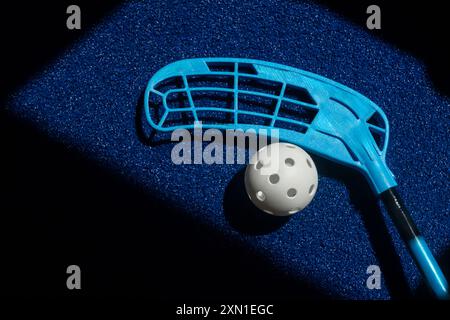 Floorball stick and white ball on blue background. Horizontal sport theme poster, greeting cards, headers, website and app Stock Photo