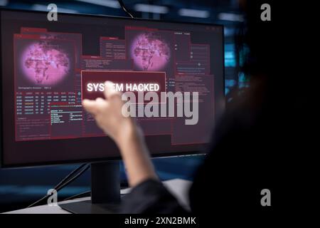 Admin in server hub establishment frightened by hacker passing firewall and stealing data. Close up shot of security breach notification on monitor in data center making IT expert panic Stock Photo