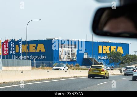 Palma, Spain - Jun 28, 2023: Approaching IKEA in Palma de Mallorca with a large logotype and Muebles y Decoracion inscription on the facade, as seen from inside a driving car, capturing the store s prominent exterior and signage Stock Photo