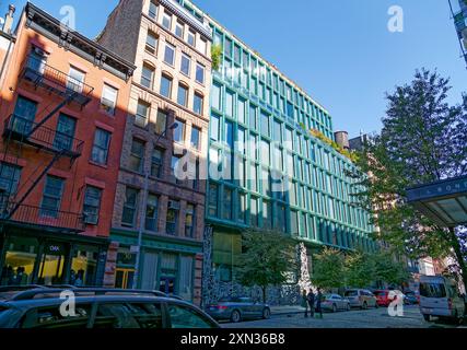 40 Bond Street, a modern condo incorporated in the NoHo Historic District Extension. An aluminum sculpture screens the blue-green glass façade. Stock Photo