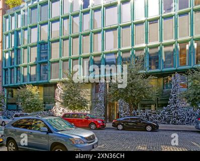 40 Bond Street, a modern condo incorporated in the NoHo Historic District Extension. An aluminum sculpture screens the blue-green glass façade. Stock Photo