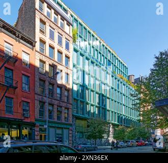 40 Bond Street, a modern condo incorporated in the NoHo Historic District Extension. An aluminum sculpture screens the blue-green glass façade. Stock Photo