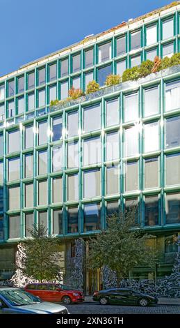 40 Bond Street, a modern condo incorporated in the NoHo Historic District Extension. An aluminum sculpture screens the blue-green glass façade. Stock Photo